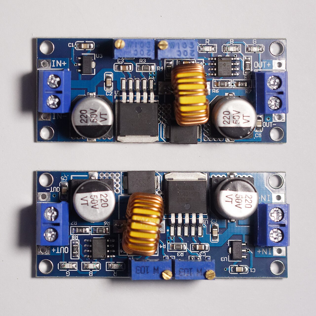 A pair of small buck converter modules built around a switching regulator chip, inductor, and trim potentiometer.