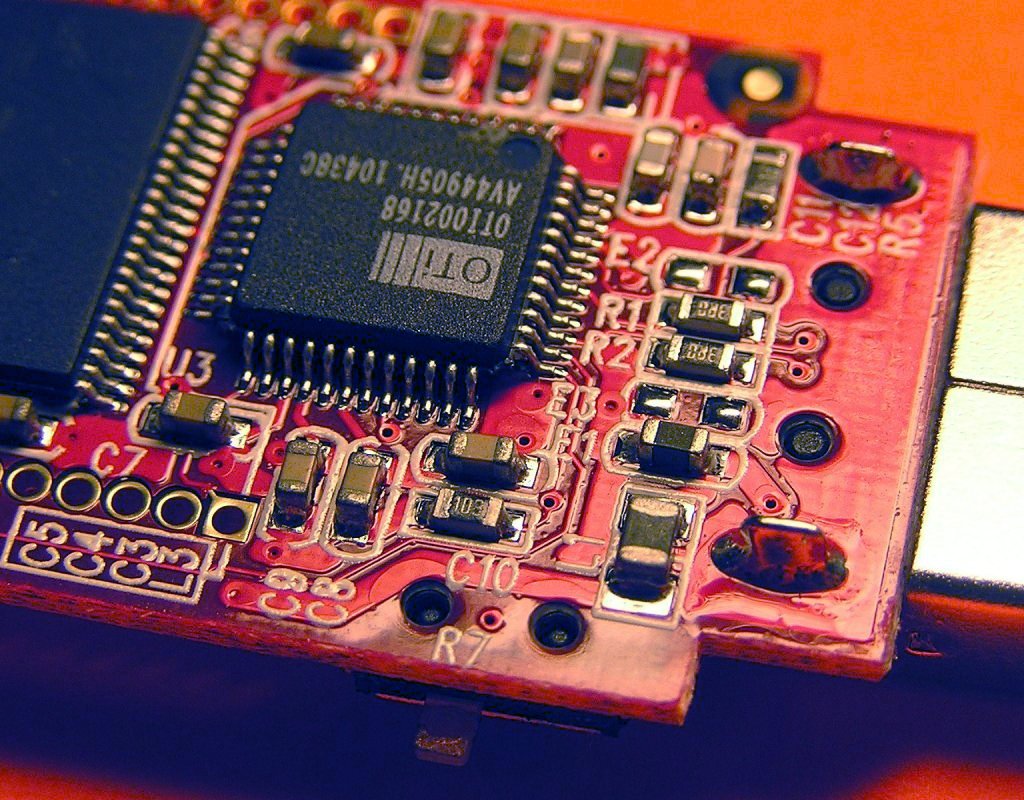Close-up of a populated circuit board covered in tiny surface-mount resistors and capacitors.